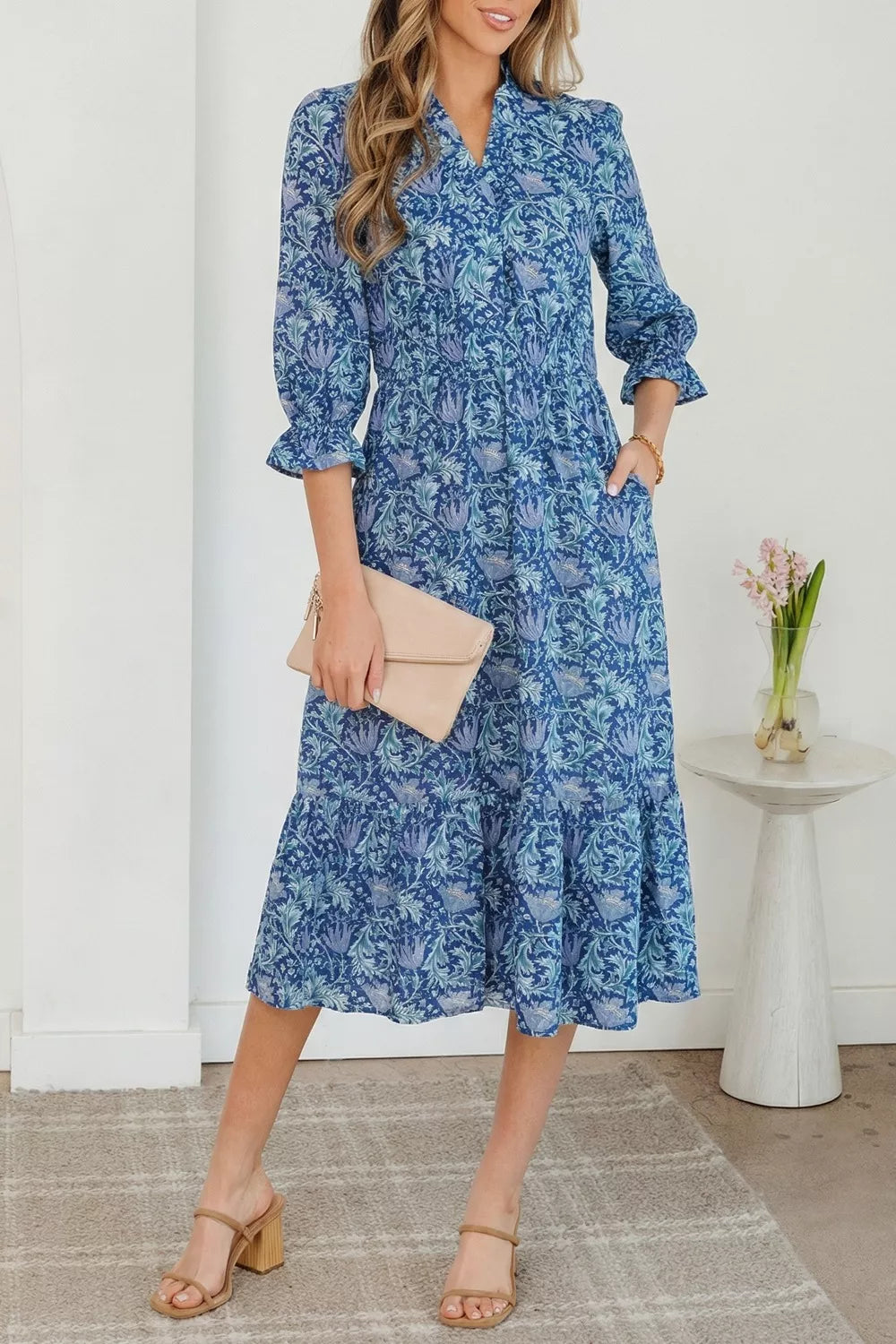 Blue floral cotton midi dress with cinched waist and frilled cuffs