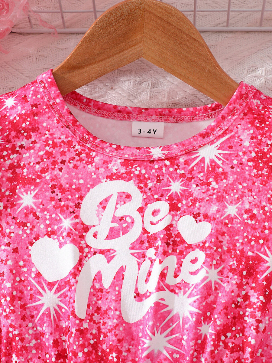 Baby dress with pink glitter print, "Be Mine" text, and puff sleeves.