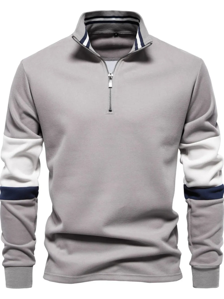 Gray zip-neck sweatshirt with colorblock sleeves and striped collar.