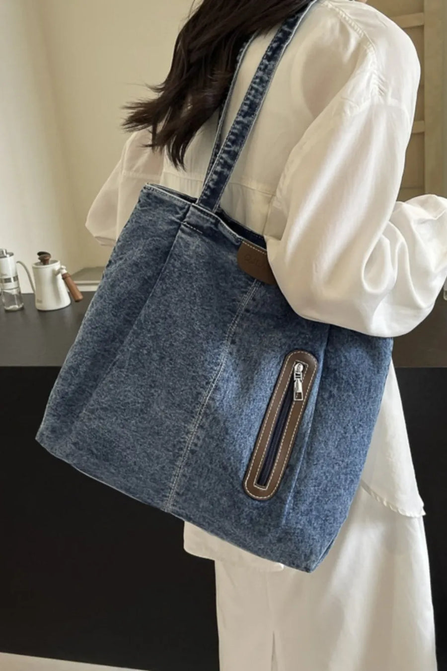 Denim tote bag with leather trim and zipper pocket, light blue wash