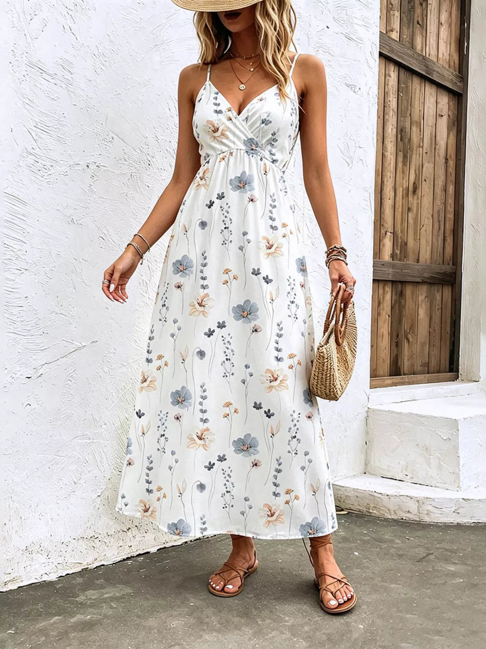 White floral print spaghetti strap midi dress with adjustable straps and a v-neckline.