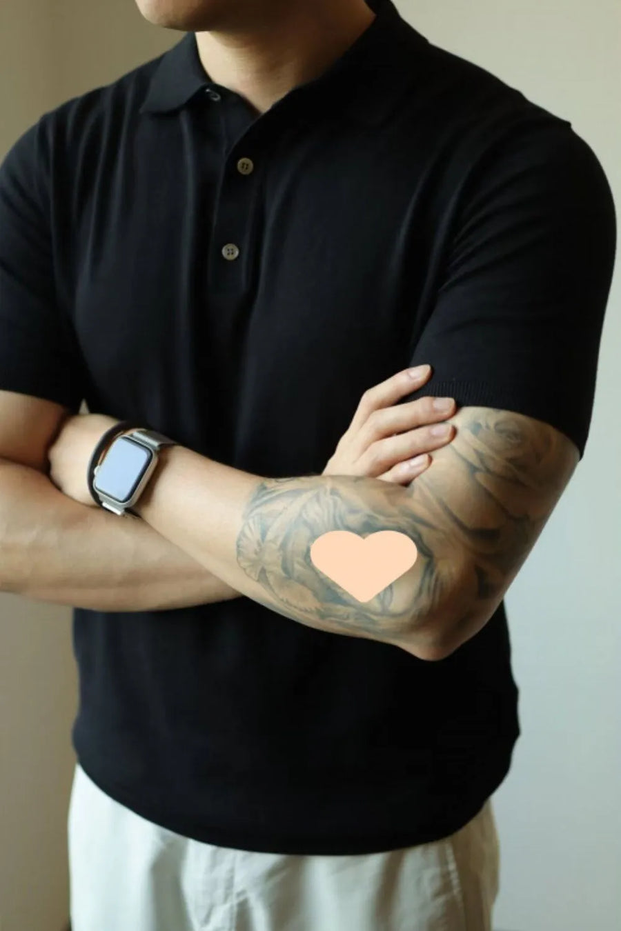 Black fine-gauge knit polo shirt with refined placket and short sleeves.
