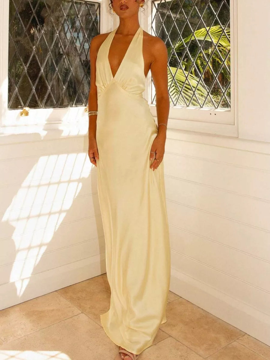 Pastel yellow backless halter neck maxi dress with a deep V-neck