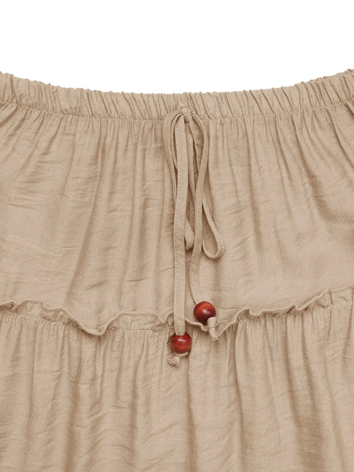 Tiered maxi skirt in tan with drawstring waist and wooden beads.