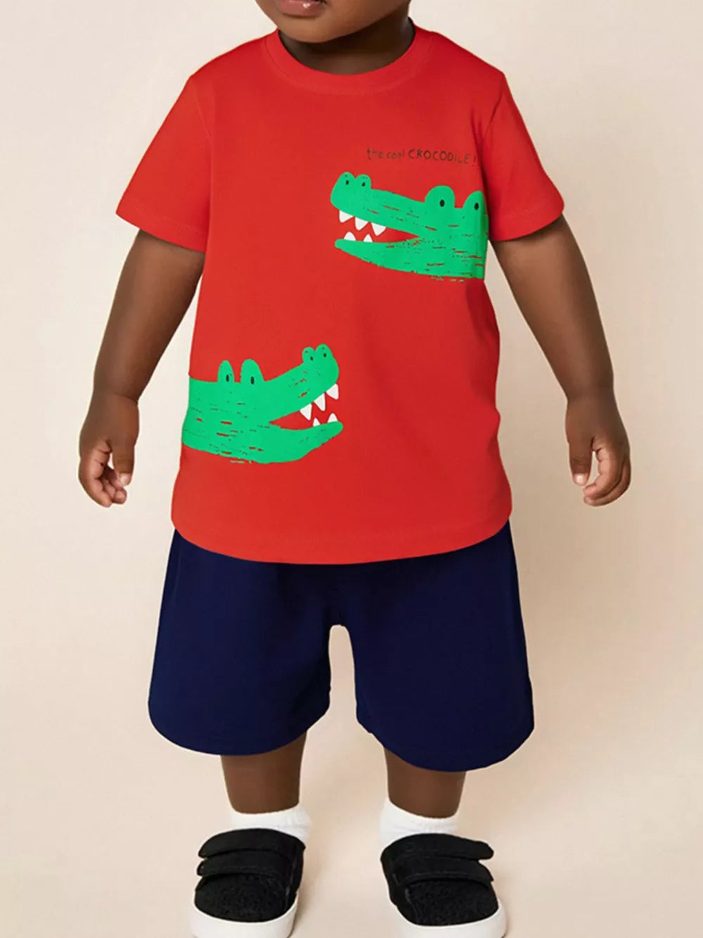 Toddler red cotton t-shirt with green crocodile print and navy shorts