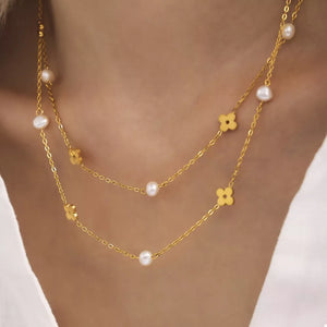cream necklace featuring flower charm and floral