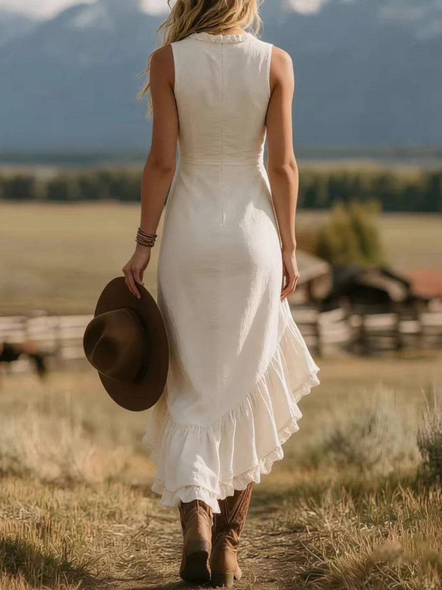 White ruffled asymmetrical hem dress with a ruffled neckline and lace trim.
