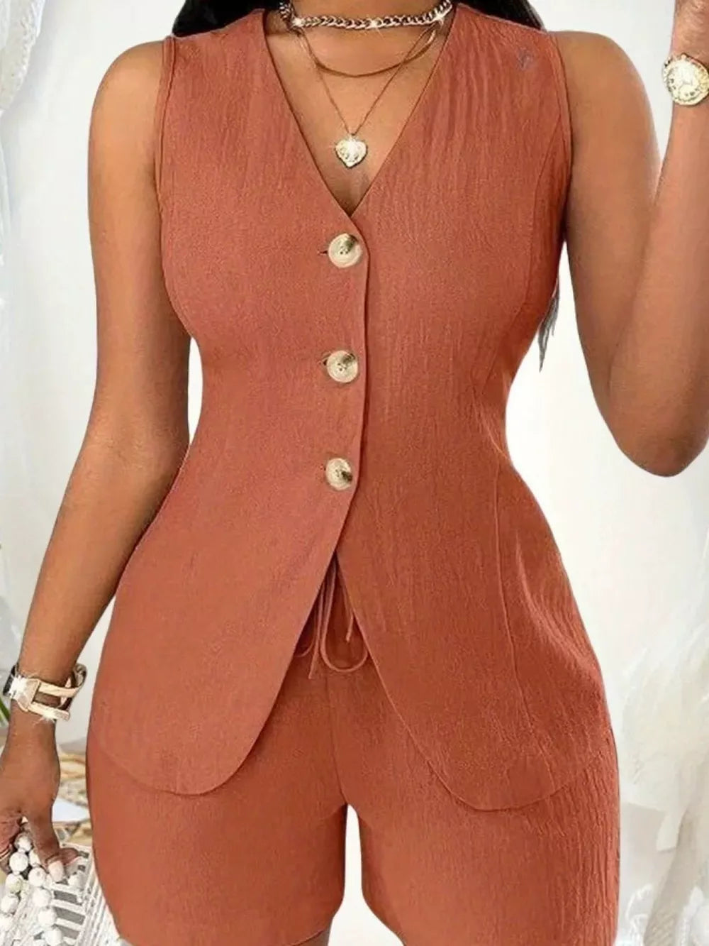 Button-down vest and shorts set in apricot with drawstring detail.