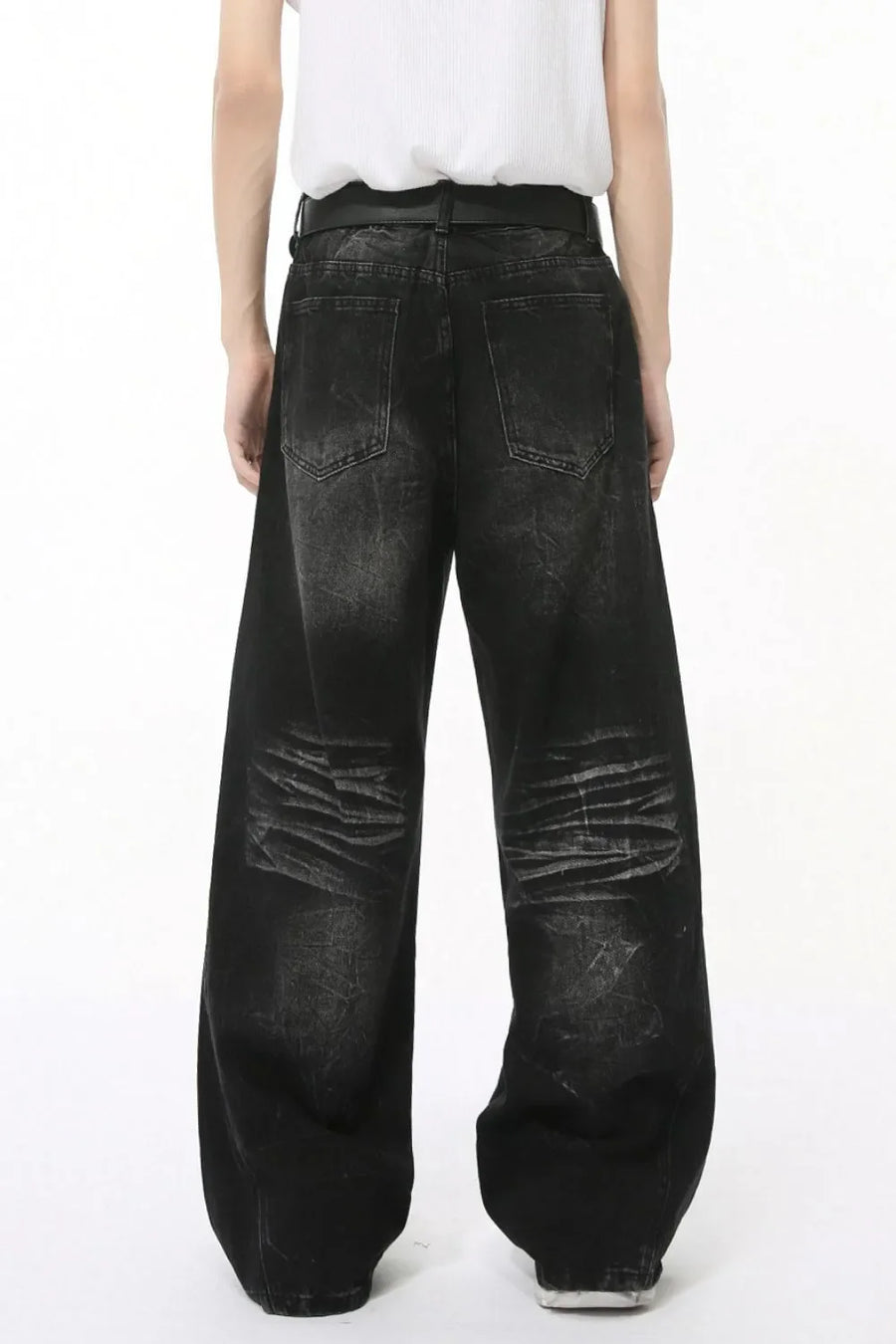 Faded black denim palazzo trousers with distressed detailing and wide legs.