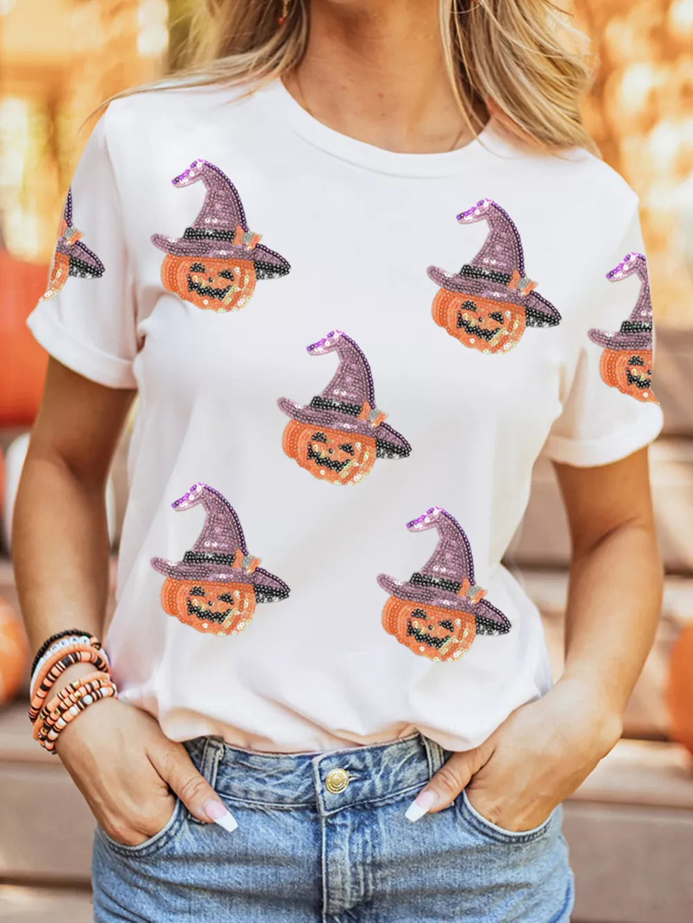 White cotton t-shirt with allover sparkling pumpkin witch graphic print