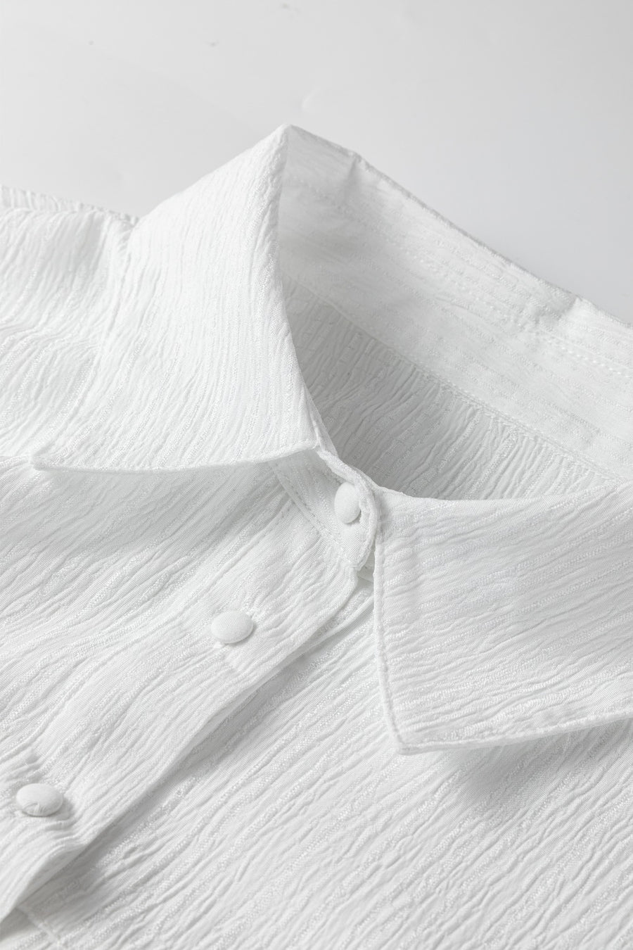White crinkled texture button-down shirt with classic collar and button detail