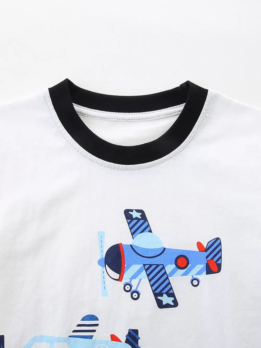 White toddler t-shirt with black trim and a blue airplane print.