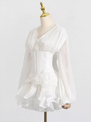 White ruffle mini dress with balloon sleeves, ruched bodice, and floral detail