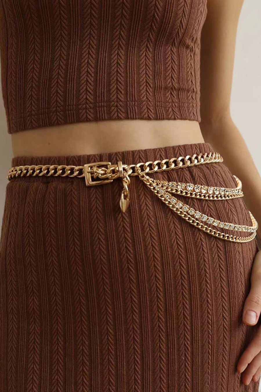Gold layered chain belt with rhinestone embellishments and a heart charm.