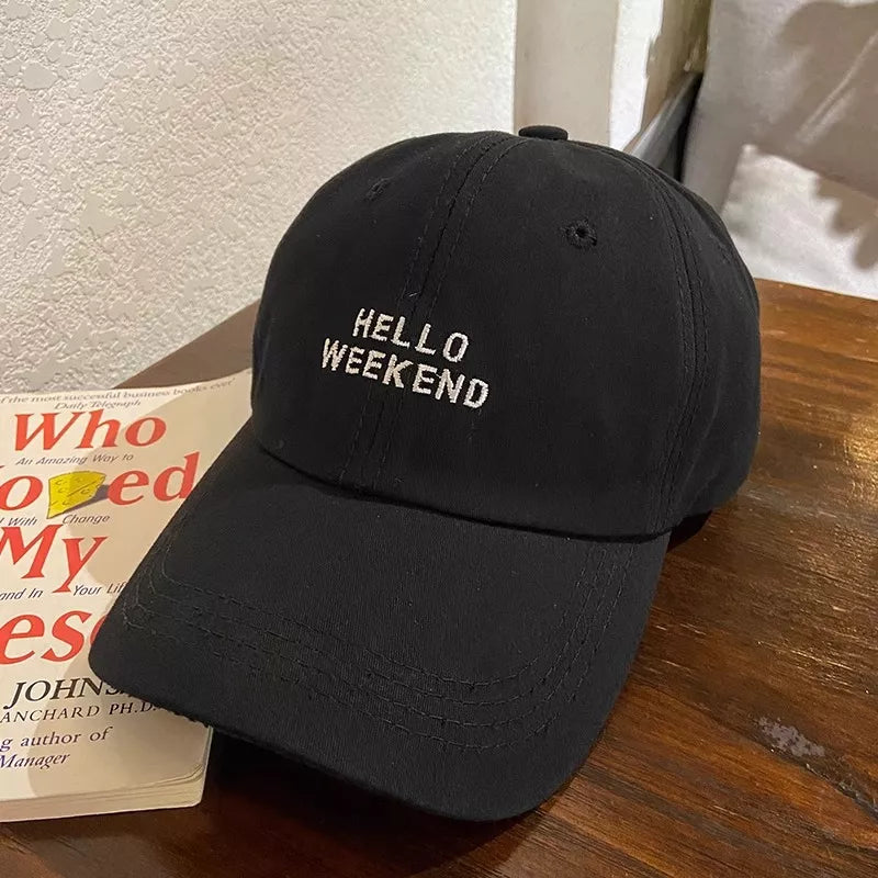 Black cotton baseball cap with white "HELLO WEEKEND" embroidery