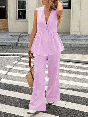 Pink V-neck sleeveless peplum top and wide-leg pants set with gold button detail.