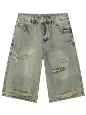 Distressed culotte denim shorts in medium wash with ripped details and a wide leg.