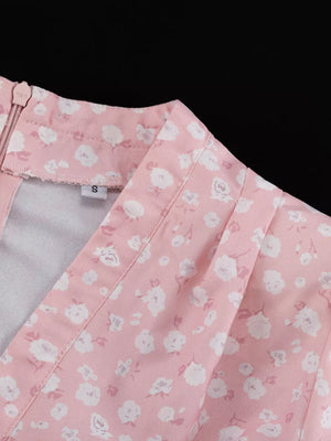 Pink floral print v-neck dress with a zipper closure and gathered detail.