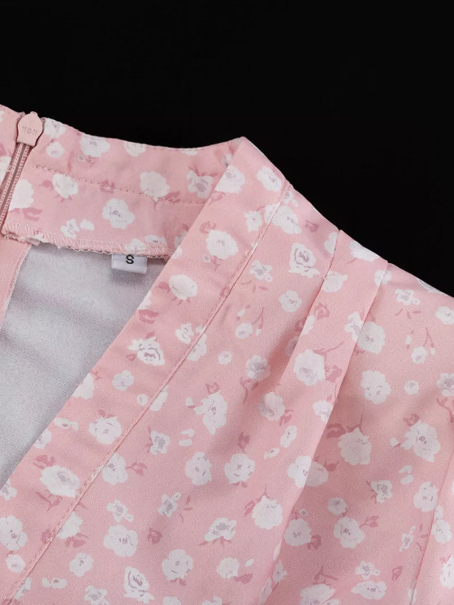 Pink floral print v-neck dress with a zipper closure and gathered detail.