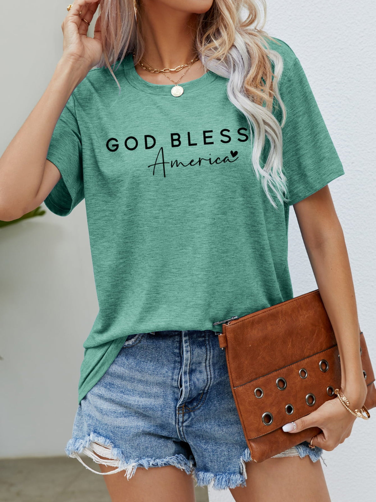 God Bless America script tee in Gum Leaf green with short sleeves and a crew neck.