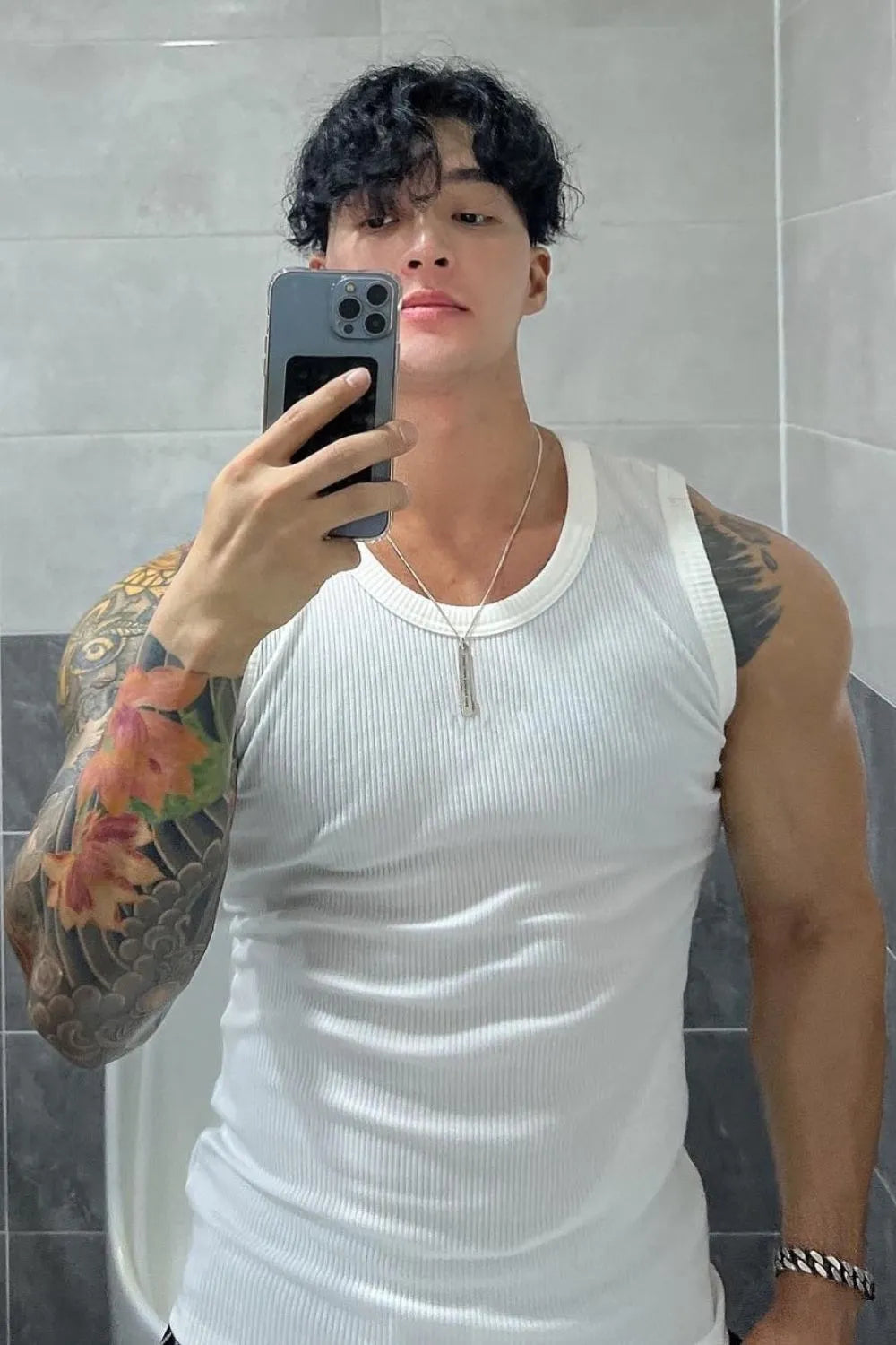 White ribbed cotton muscle tank top with crew neck and sleeveless design.