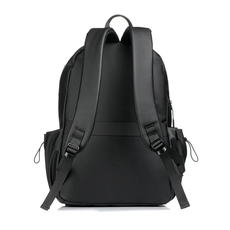 Black canvas laptop backpack with adjustable straps and side pockets.