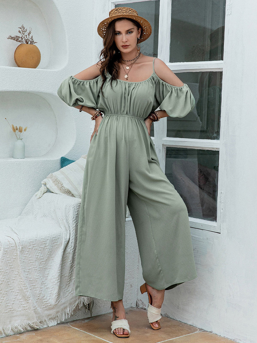 Sage off-shoulder jumpsuit with gathered waist and wide legs, featuring puff sleeves.