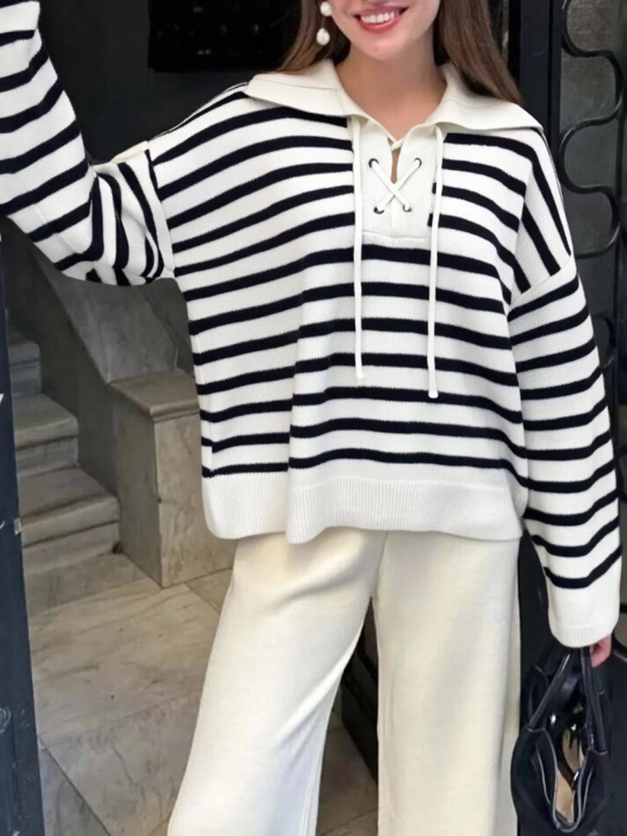 Black and white striped long-sleeve sweater with lace-up neckline and collar.