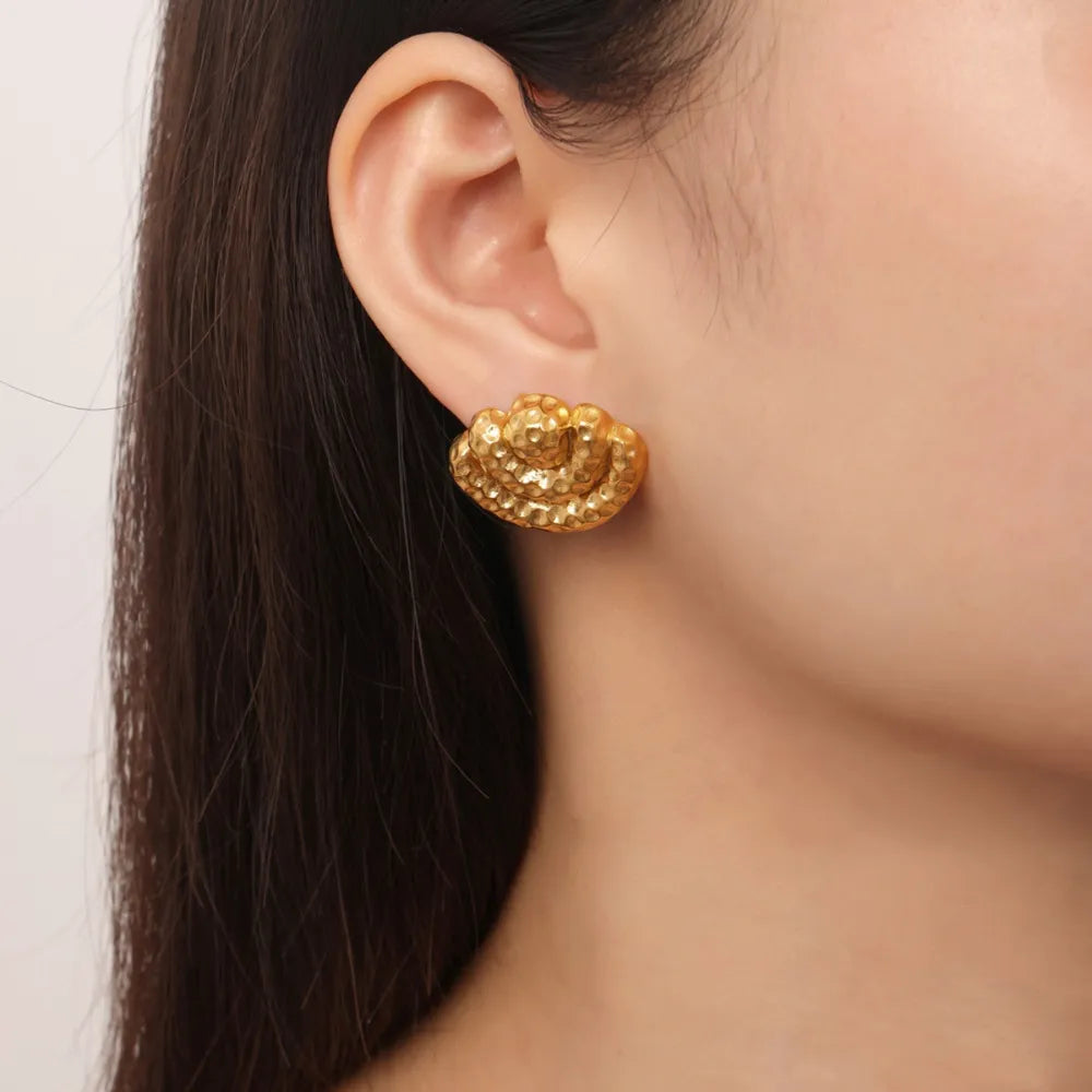 Textured shell stud earrings in gold with a hammered finish.