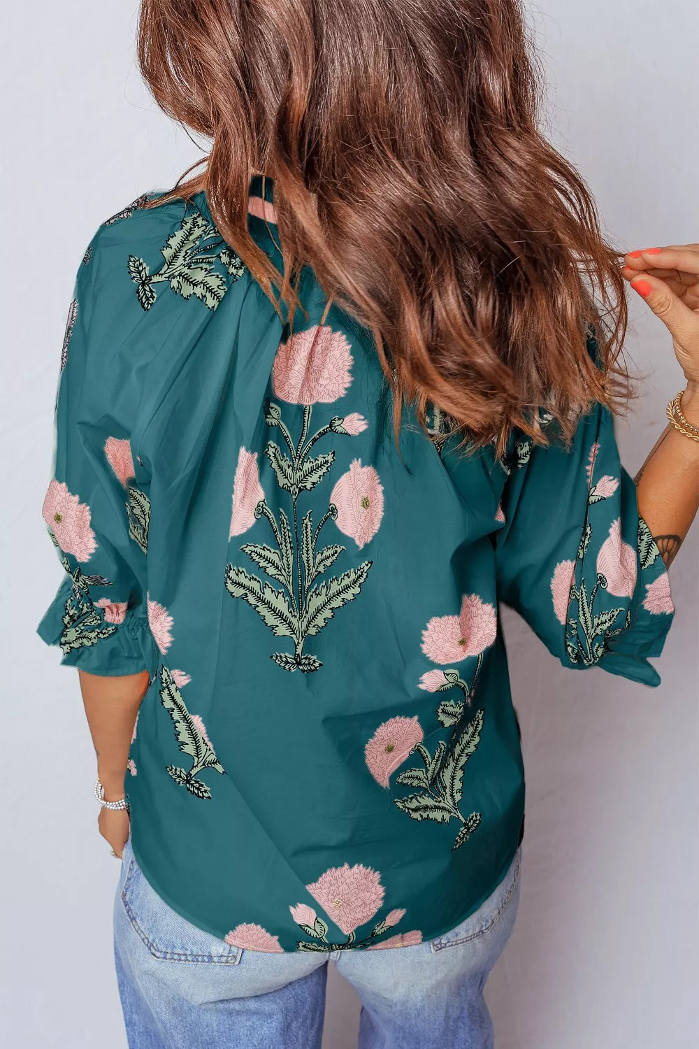 Dark green cotton blend blouse with pink floral embroidery and ruffled sleeves.