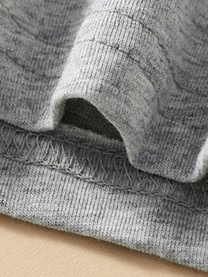 Toddler grey cotton tee and shorts set detail showing elastic waistband and stitching.