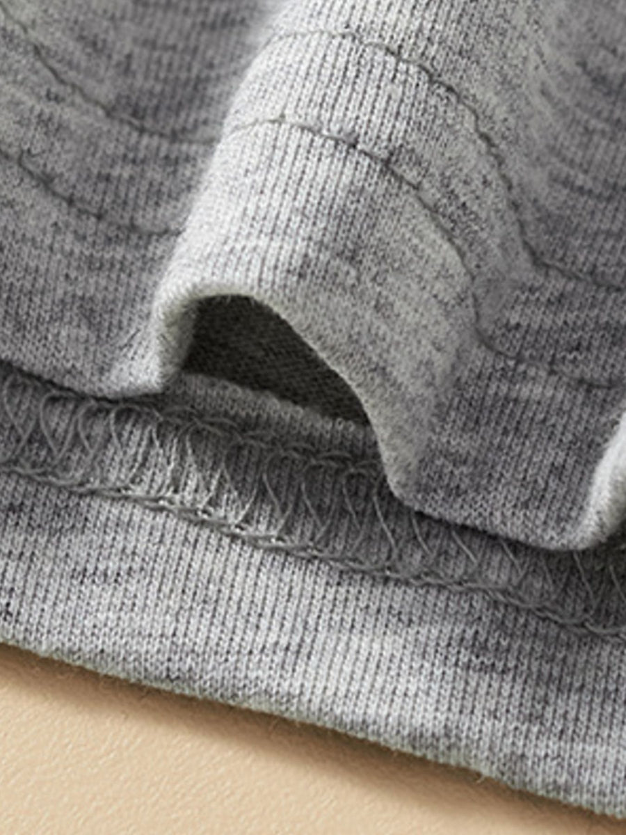 Toddler grey cotton tee and shorts set detail showing elastic waistband and stitching.