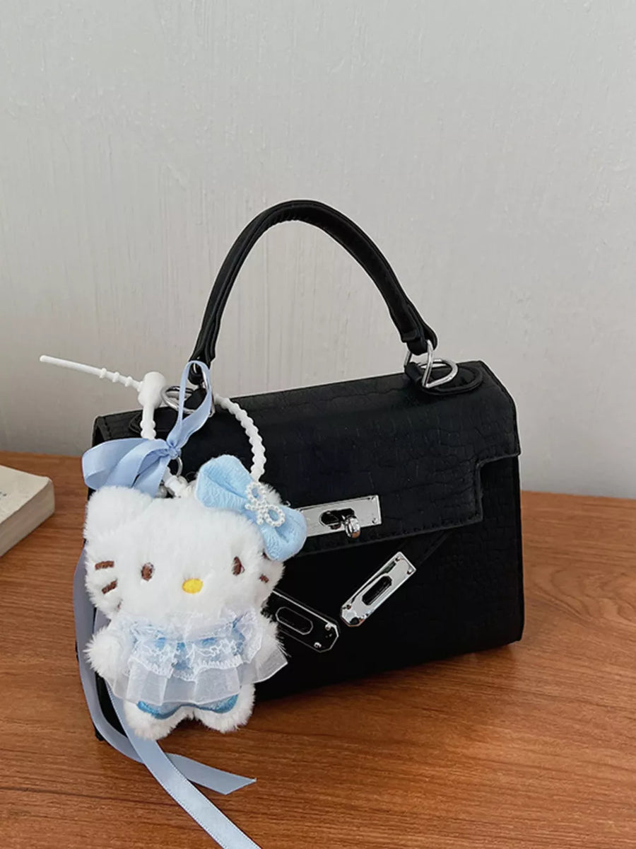 Black croc-embossed mini crossbody bag with Hello Kitty charm and blue ribbon detail.