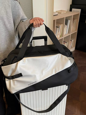 Oxford cloth travel bag in black and silver with diagonal color block and text detail.