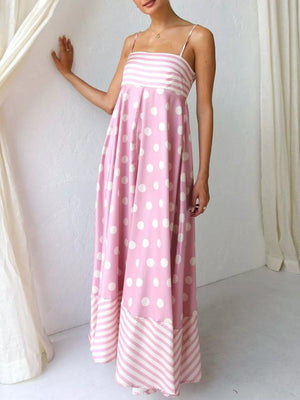 Blush pink maxi dress with spaghetti straps, polka dot print and striped hem.