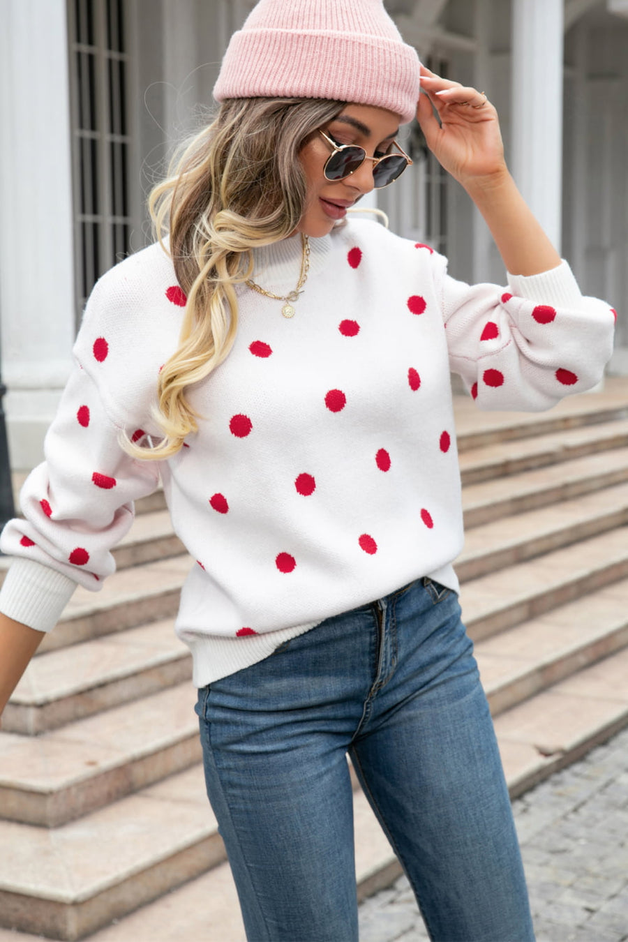 White polka dot knit sweater with balloon sleeves and crew neck.