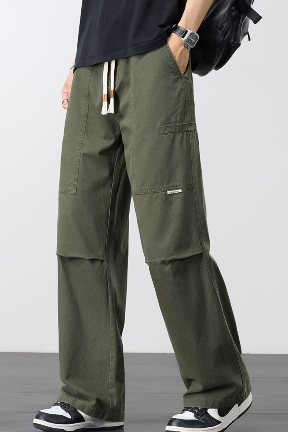 Army green cargo pants with adjustable drawstring and multiple pockets.