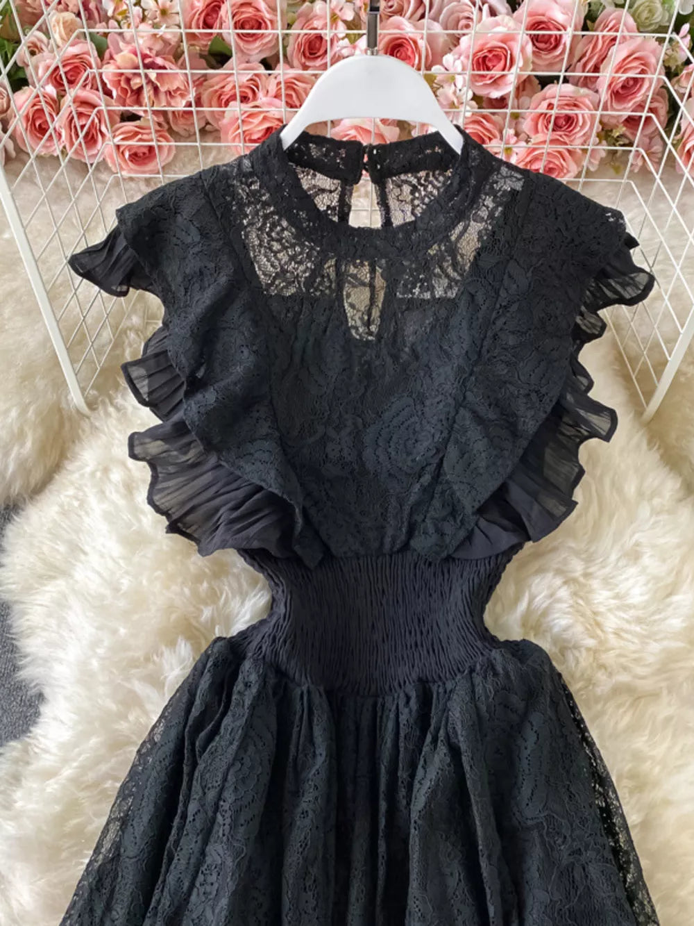 Black lace maxi dress with ruffled sleeves, cutout waist, and high neckline.