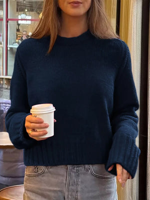Navy ribbed round-neck knit sweater with long sleeves.
