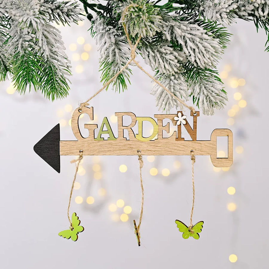 Spring Garden wooden sign with arrow, keyhole, and green butterflies.