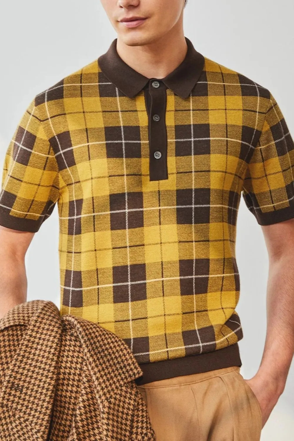 Checked knit polo shirt with contrast trim in plaid yellow and brown acrylic.