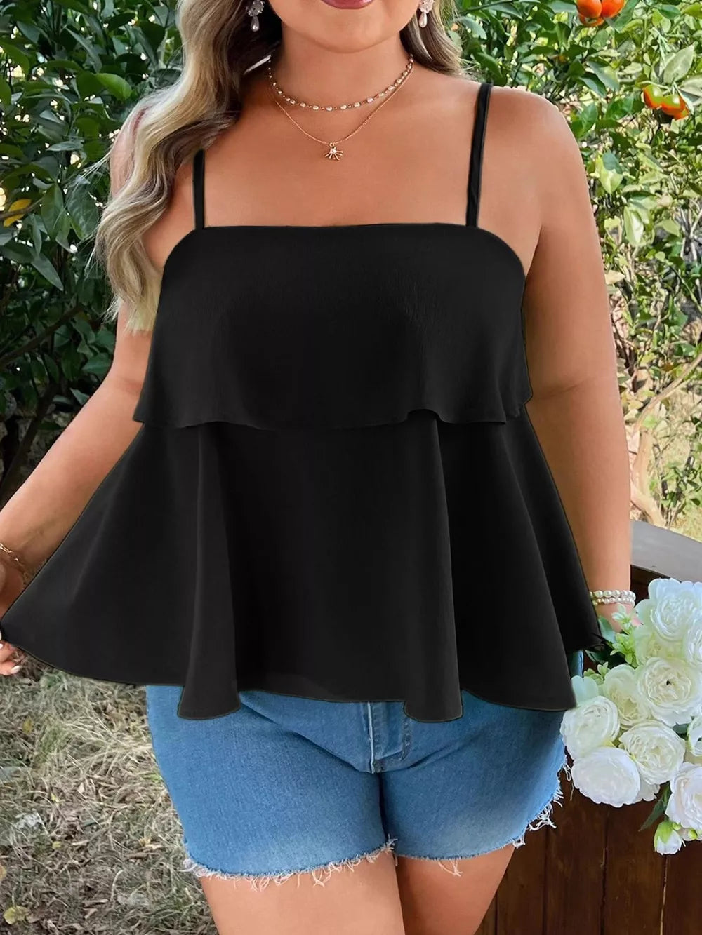 Black plus-size cami with square neck, ruffle tiers, and spaghetti straps.
