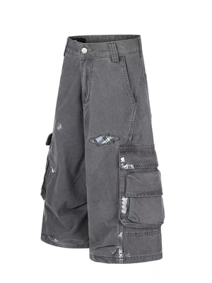 Gray cargo capris with distressed detailing and plaid patches.