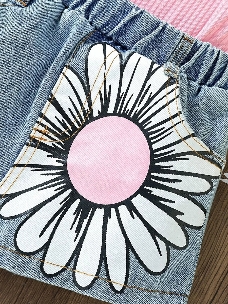 Toddler denim shorts with pink floral applique and pink ribbed cami detail.