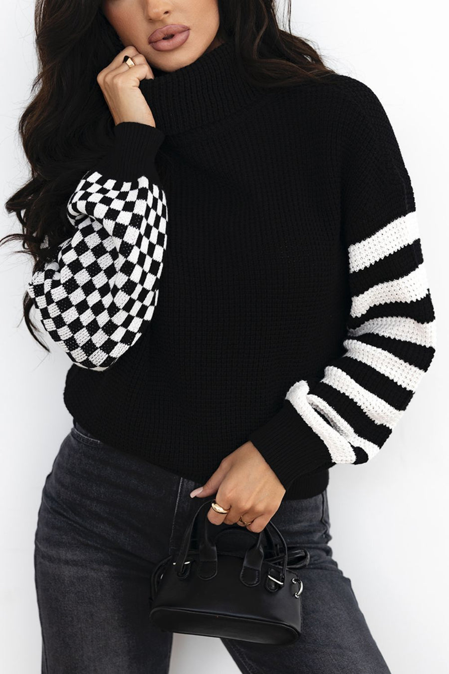 Black acrylic turtleneck sweater with checkerboard and stripe sleeves