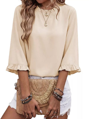 Apricot ruffled mock neck half sleeve shirt with ruffled cuffs.