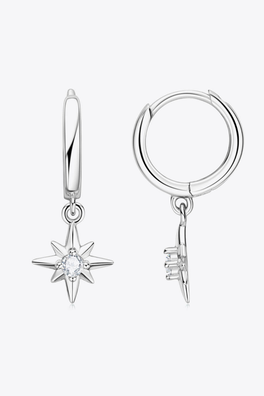 Silver hoop earrings with dangling star charms featuring a central crystal