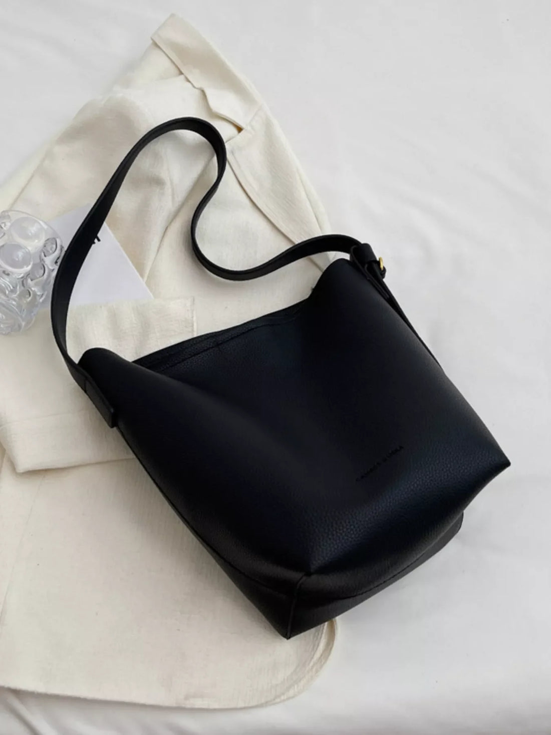 Black minimalist PU leather shoulder bag with adjustable strap