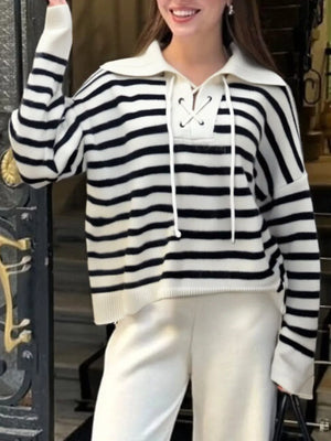 Black and white striped sweater with lace-up neckline and collar.