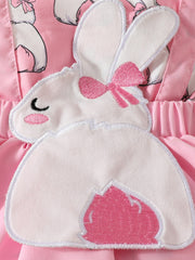 Pink baby dress with bunny applique and bow detail.